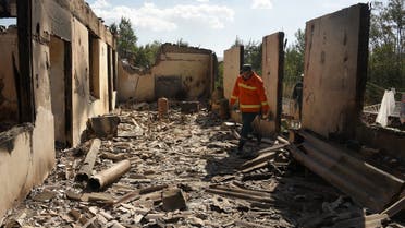 Firefighters work among the ruins of a house, which is said was hit by Azeri shelling during clashes with Azerbaijan, Sept. 14, 2022. (AFP)