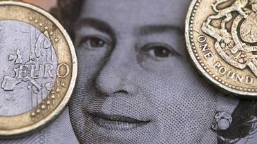 A two Euro coin is pictured next to a one Pound coin on top of a portrait of Britain's Queen Elizabeth in this file photo illustration shot March 16, 2016. (Reuters)