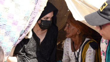 Angelina Jolie listens to a displaced woman following rains and floods during the monsoon season, in village Ibrahim Chandio, Dadu, Pakistan September 20, 2022. (Reuters)