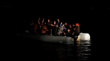 Migrants wave and shout for help following a failed attempt of crossing to the Greek island of Lesbos as a Turkish Coast Guard boat aproaches them on the waters of the North Aegean Sea, off the shores of Canakkale, Turkey, March 6, 2020. REUTERS/Umit Bektas