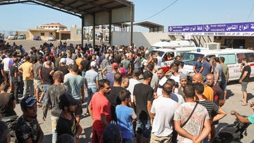 People gather following the sinking of a migrant boat, that according to Lebanese and Syrian officials sank off at Syrian coast after sailing from Lebanon, at the Lebanese-Syrian border crossing in Arida, Lebanon, on September 23, 2022. (Reuters)