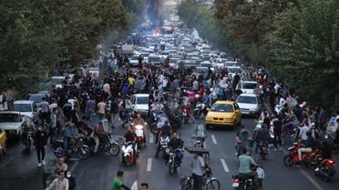 A picture obtained by AFP outside Iran on September 21, 2022, shows Iranian demonstrators burning a rubbish bin in the capital Tehran during a protest for Mahsa Amini, days after she died in police custody. Protests spread to 15 cities across Iran overnight over the death of the young woman Mahsa Amini after her arrest by the country's morality police, state media reported today.In the fifth night of street rallies, police used tear gas and made arrests to disperse crowds of up to 1,000 people, the official IRNA news agency said.
