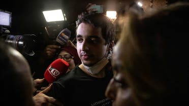 Brahim Saadoun, a Moroccon who was sentenced to death in June by the unrecognised Donetsk People's Republic, is surrounded by press after his arrival in Casablanca on September 24, 2022, two days after being released as part of a prisoner exchange between Ukraine and Russia. (AFP)