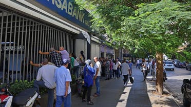 Lebanese depositors queue to withdraw money from a Fransabank branch in Beirut on September 26, 2022 as banks partially re-opened following a week of closure due to security concerns. (AFP)