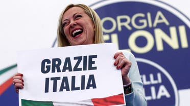 Leader of Brothers of Italy Giorgia Meloni holds a sign at the party's election night headquarters, in Rome, Italy September 26, 2022. (Reuters)