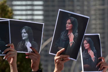 Women hold up signs depicting the image of 22-year-old Mahsa Amini. (File photo: AFP)