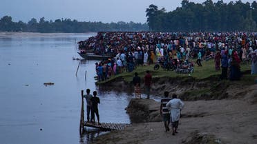 In this picture taken on September 25, 2022, people gather along the banks of the Karatoya river after a boat capsized near the town of Boda. (AFP)