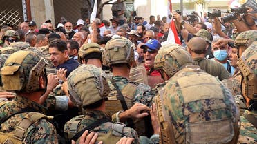 Lebanese army soldiers clash with retired military personnel as they try to break into the parliament in Beirut on September 26, 2022, during a session to approve the 2022 budget. (AFP)