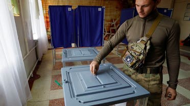 A service member of the self-proclaimed Donetsk People's Republic (DPR) casts his ballot at a polling station during a referendum on the joining of DPR to Russia, in Donetsk, Ukraine September 27, 2022. (Reuters)