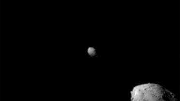 The last image to contain a complete view of asteroid Didymos (top left) and its moonlet, Dimorphos, about 2.5 minutes before the impact of NASA’s DART spacecraft, taken by the on board DRACO imager from a distance of 920 kilometers, and released September 26, 2022. (Reuters)