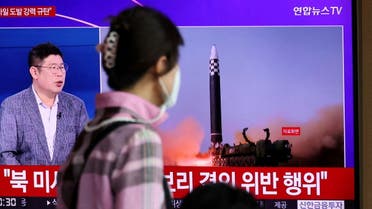 A woman watches a TV broadcasting a news report on North Korea's launch of three missiles including one thought to be an intercontinental ballistic missile (ICBM), in Seoul, South Korea, May 25, 2022. REUTERS/Kim Hong-Ji TPX IMAGES OF THE DAY