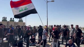 Protesters scuffle with riot police in Iraq’s Baghdad