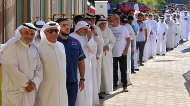 Kuwaitis queue up outside a polling station to vote during parliamentary elections in Kuwait City on September 29, 2022. (AFP)