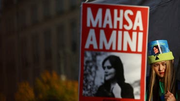A demonstrator looks on during a protest following the death of Mahsa Amini in Iran, near the Brandenburg Gate, in Berlin, Germany, September 28, 2022. (Reuters)