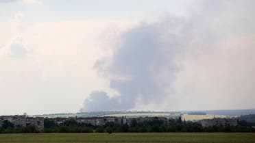 Black smoke is seen over the city of Lyman, Donetsk region, moving from the territory of the Luhansk region on June 14, 2022. (AFP)