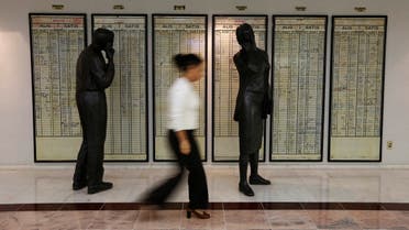 A stock exchange employee walks past an old notice board at Bourse Istanbul. (File photo: Reuters)
