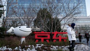 A man stands outside JD.com’s headquarters in Beijing, China. (File photo: Reuters)
