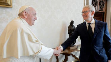 Pope Francis shakes hands with Apple chief Tim Cook during a private audience at the Vatican, October 3, 2022. Handout from Vatican Media. (Reuters)