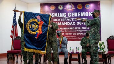 Philippine Marine Brigadier General Raul Jesus Caldez and US Marine Corporal Colonel Deric Ayers unfurl the flag during the opening ceremony of the joint military exercises Kamandag or the “Cooperation of the Warriors of the Sea,” at the headquarters of Philippine Marine Corps, in Taguig City, Metro Manila, Philippines, October 3, 2022. (Reuters)