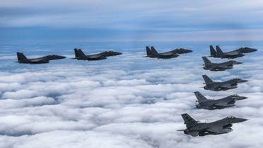 This handout photo taken on October 4, 2022 and provided by the South Korean defense ministry in Seoul shows four South Korean Air Force F-15Ks and four US Air Force F-16 fighters flying over South Korea, during a precision bombing drill in response to North Korea firing an intermediate range ballistic missile over Japan. (AFP)