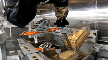 The Flippy 2 robot takes fries out of a vat of oil at a lab of manufacturer Miso Robotics Inc in Pasadena, California, US, on September 27, 2022, in this screen grab. (Reuters)