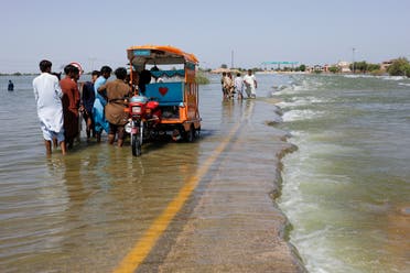 Displaced people stand on flooded highway, following rains and floods during the monsoon season in Sehwan, Pakistan, September 16, 2022. (File Photo: Reuters)
