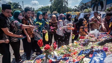 People pay their respects for victims of the stampede at Kanjuruhan stadium in Malang, East Java on October 4, 2022. (AFP)
