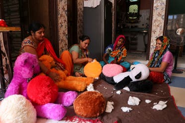Women workers make soft toys using recycled fibre separated from cigarette filter tips at a cigarette butts recycling factory in Noida, India September 12, 2022. (Reuters)