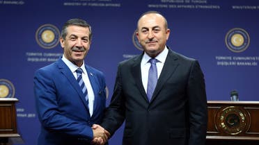 Turkish Foreign Minister Mevlut Cavusoglu (R) and Turkish Cypriot Foreign Affairs Minister Tahsin Ertugruloglu shake hands following a joint press conference after their meeting in Ankara, on June 22, 2016. (AFP)