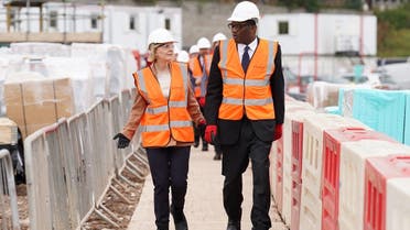 British Prime Minister Liz Truss and Chancellor of the Exchequer Kwasi Kwarteng walk during a visit to a construction site for a medical innovation campus, on day three of the Conservative Party annual conference at the International Convention Centre in Birmingham, Britain, on October 4, 2022. (Reuters)