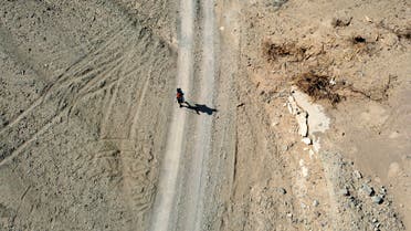 Saudi trekker Abdullah Alsulmi crosses a desert area near al-Khasrah area, some 350Km west of Riyadh, on Septembre 27, 2022, during his solo trek to the Qatari capital ahead of the FIFA World Cup. (AFP)