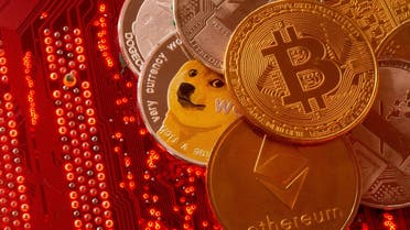 Representations of cryptocurrencies Bitcoin, Ethereum, DogeCoin, Ripple, Litecoin are placed on PC motherboard in this illustration. (Reuters)