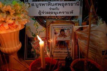 A picture of a child victim is displayed at Wat Rat Samakee temple, which houses coffins of victims for people to pray next to, following a mass shooting in the town of Uthai Sawan, Nong Bua Lam Phu province, Thailand, on October 7, 2022. ((Reuters)