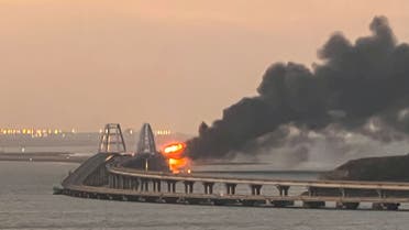 A view shows a fire on the Kerch bridge at sunrise in the Kerch Strait, Crimea, October 8, 2022. REUTERS/Stringer