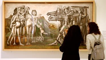 Visitors inspect Pablo Picasso's Massacres in Korea during the official opening of the exhibition Picasso: War & Peace in central Barcelona, May 25, 2004. The exhibition will continue until 26th September. (Reuters)