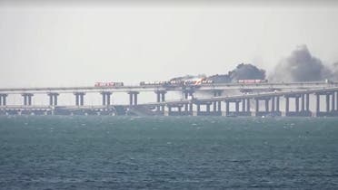  A screen grab from a video showing fire on Crimea's damaged Kerch bridge, which links Crimea with Russia's Krasnodar region, October 8, 2022. (Reuters) 