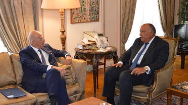 A handout picture released by the twitter account of the Egyptian Ministry of Foreign Affairs spokesperson, shows Egyptian Foreign Minister Sameh Shoukry (R) meeting with his Greek counterpart Nikos Dendias, in the capital Cairo, on October 9, 2022. (AFP)