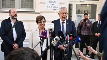 Austria’s President Alexander Van der Bellen and his wife Doris speak to the media in front of a polling station in Vienna, during the presidential elections on October 9, 2022. (AFP)