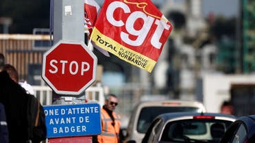 A flag of French CGT labour union flutters as workers on strike gather in front of the TotalEnergies oil refinery in Gonfreville-l'Orcher, France, on October 5, 2022. (Reuters)