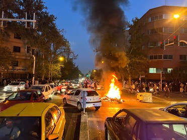 A police motorcycle burns during a protest over the death of Mahsa Amini, a woman who died after being arrested by the Islamic republic's morality police, in Tehran, Iran September 19, 2022. (Reuters)