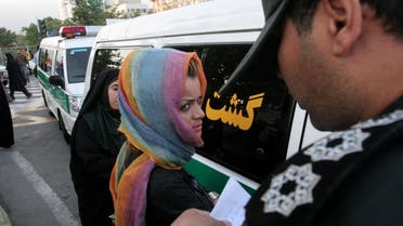 Morality police take down the name of a detained woman during a crackdown on social corruption in north Tehran June 18, 2008. Picture taken June 18, 2008. REUTERS/Stringer (IRAN)