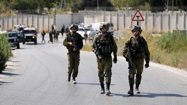 Israeli military forces work near the site where a soldier was injured by gunfire near the West Bank Jewish settlement of Shavei Shomron, Tuesday, Oct. 11, 2022. (AP Photo/Majdi Mohammed)