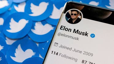 Elon Musk's Twitter profile is seen on a smartphone placed on printed Twitter logos in this picture illustration taken April 28, 2022. (Reuters)
