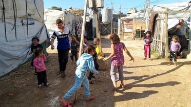 Syrian refugee children play together near tents at an informal tented settlement in Akkar, Lebanon October 19, 2021. Picture taken October 19, 2021. (Reuters)