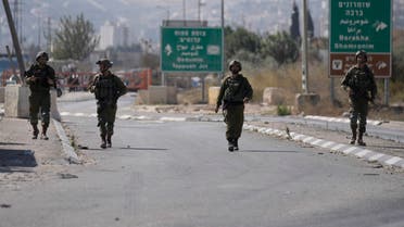 Israeli soldiers forces block the Hawara checkpoint, the main entrance to the West Bank city of Nablus, Wednesday, Oct. 12, 2022. (AP Photo/Majdi Mohammed)