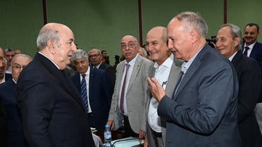 A handout picture provided by the Algerian Presidency’s official Facebook Page on October 12, 2022 shows Algerian President Abdelmadjid Tebboune (L) greets Wasel Abu Yousef (R), a member of the PLO’s Executive Committee, during the inter-Palestinian reconciliation meeting in the capital Algiers. (Photo by Algerian Presidency's Facebook page/AFP)
