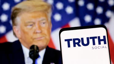 The Truth social network logo is seen on a smartphone in front of a display of former U.S. President Donald Trump in this picture illustration taken February 21, 2022. (File Photo: Reuters)