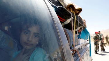 A Syrian refugee girl who left Lebanon looks through a window as she arrives in Qalamoun, Syria. (File Photo: Reuters)