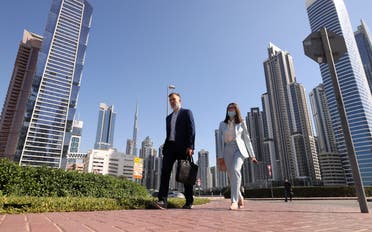 Employees walk to work on the first working Friday in the Gulf Emirate of Dubai, on January 7, 2022. (File photo: AFP)