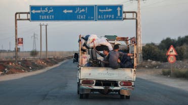 Syrians move away with their belongings north of Azaz in the country’s northern Aleppo province on October 17, 2022, to flee an Hayat Tahrir al-Sham (HTS) extremist group’s advance. (AFP)